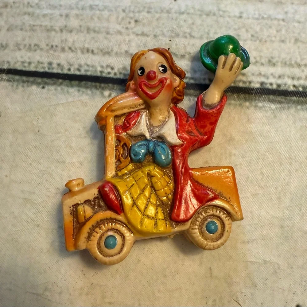 Vintage clown figurine riding in a car. Made in Japan.